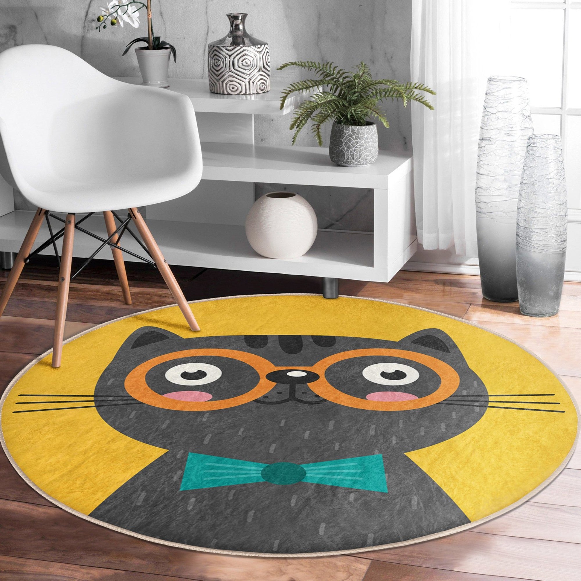 A vibrant yellow round rug featuring a whimsical cat print, perfect for adding charm to any room decor.
