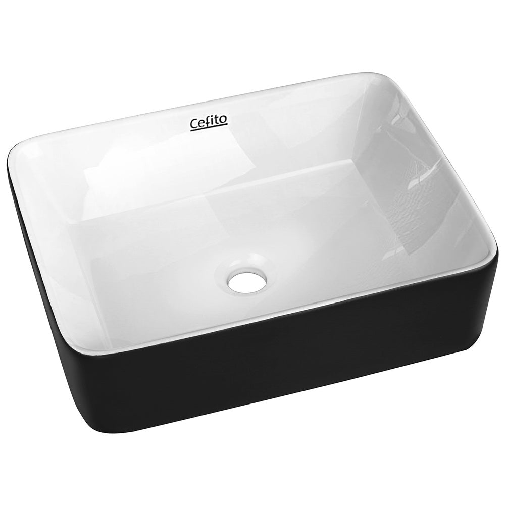 Cefito Ceramic Bathroom Basin Sink with a distinctive oval shape, featuring a matte black exterior and high gloss white interior, showcasing its elegant design.