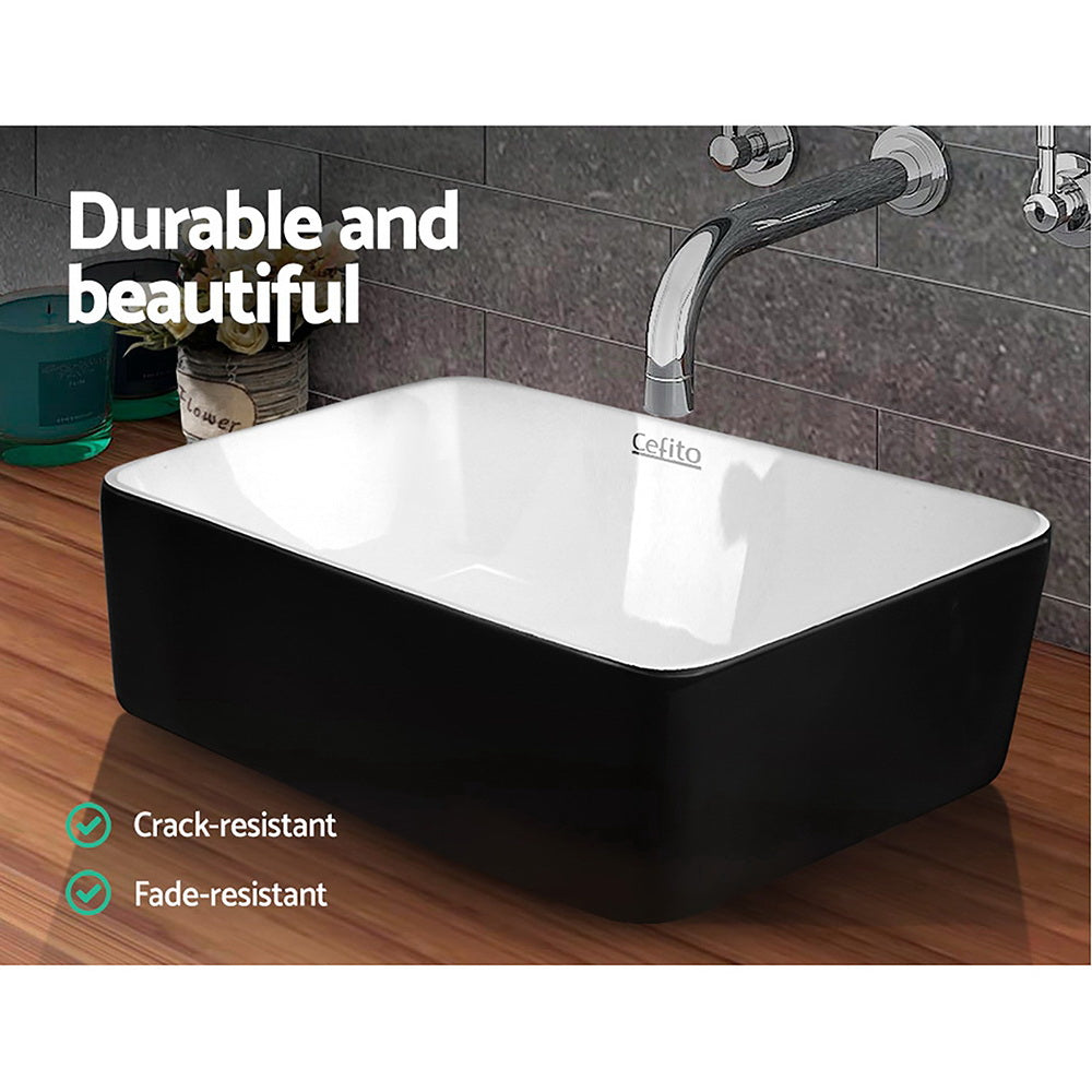 Cefito Ceramic Bathroom Basin Sink with a distinctive oval shape, featuring a matte black exterior and high gloss white interior, showcasing its elegant design.