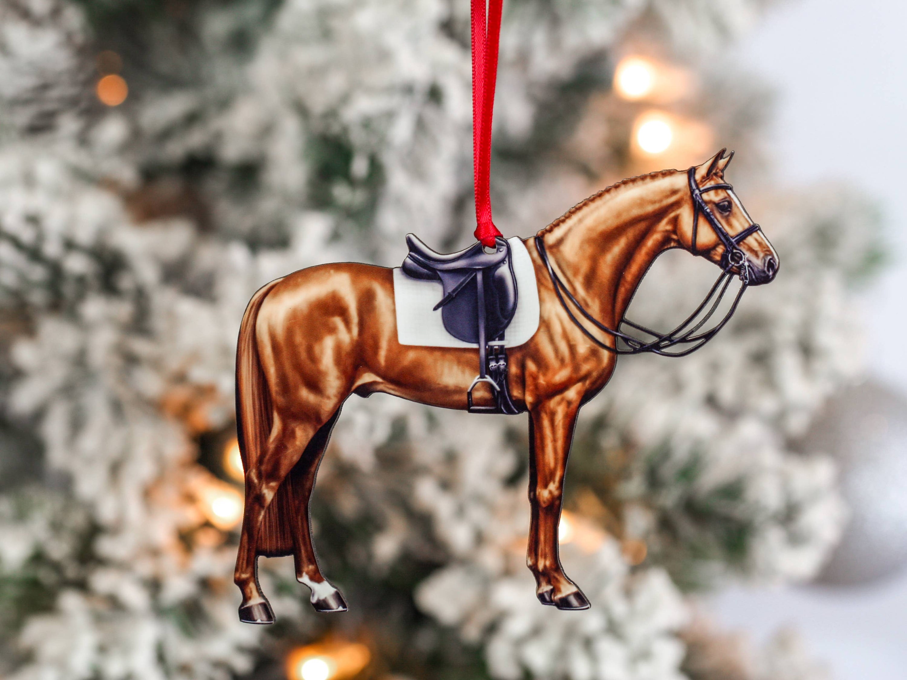 Handcrafted Chestnut Dressage Horse Christmas Ornament with red and black ribbons, made from composite wood, showcasing intricate laser-cut details.