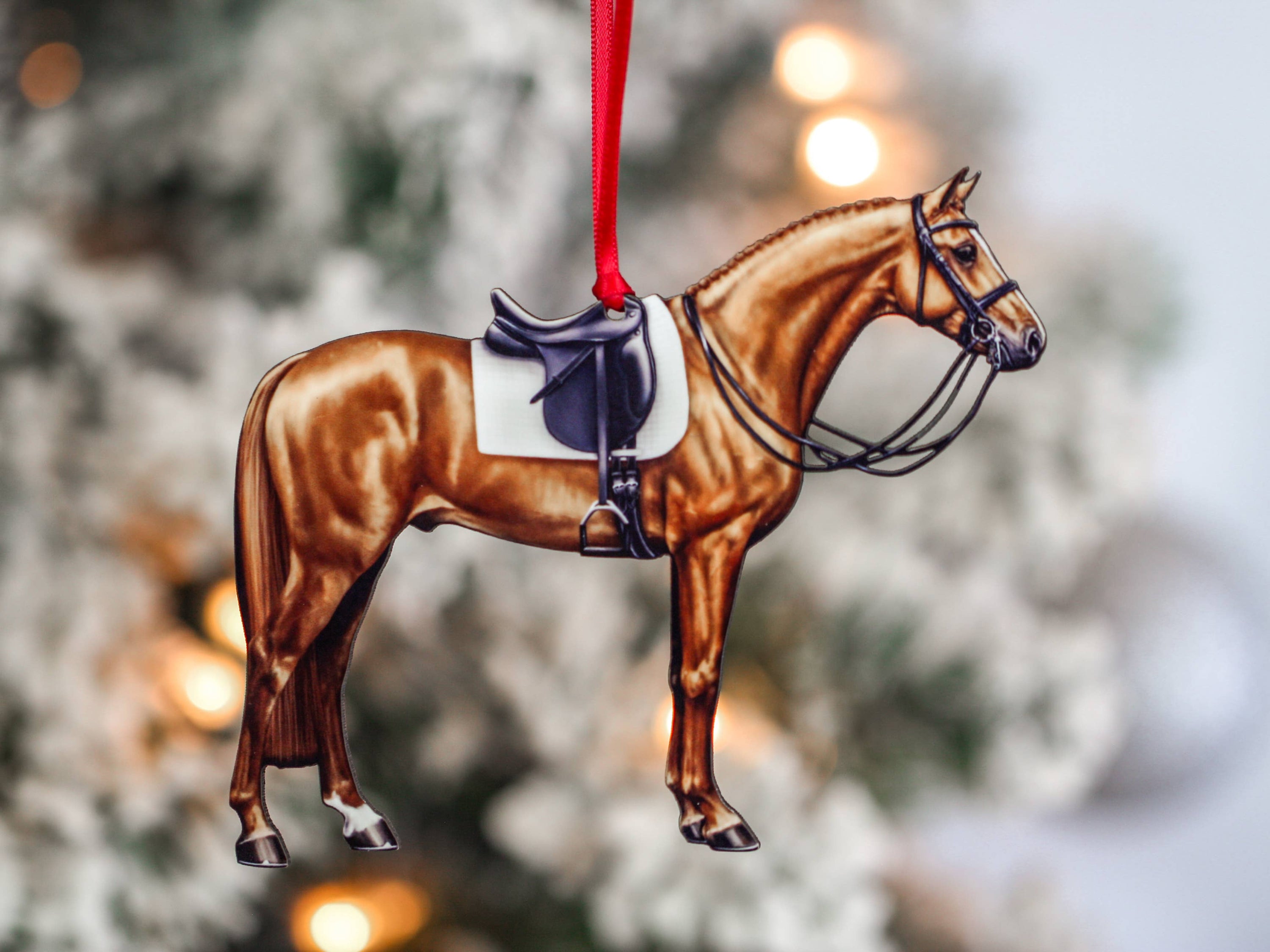 Handcrafted Chestnut Dressage Horse Christmas Ornament with red and black ribbons, made from composite wood, showcasing intricate laser-cut details.