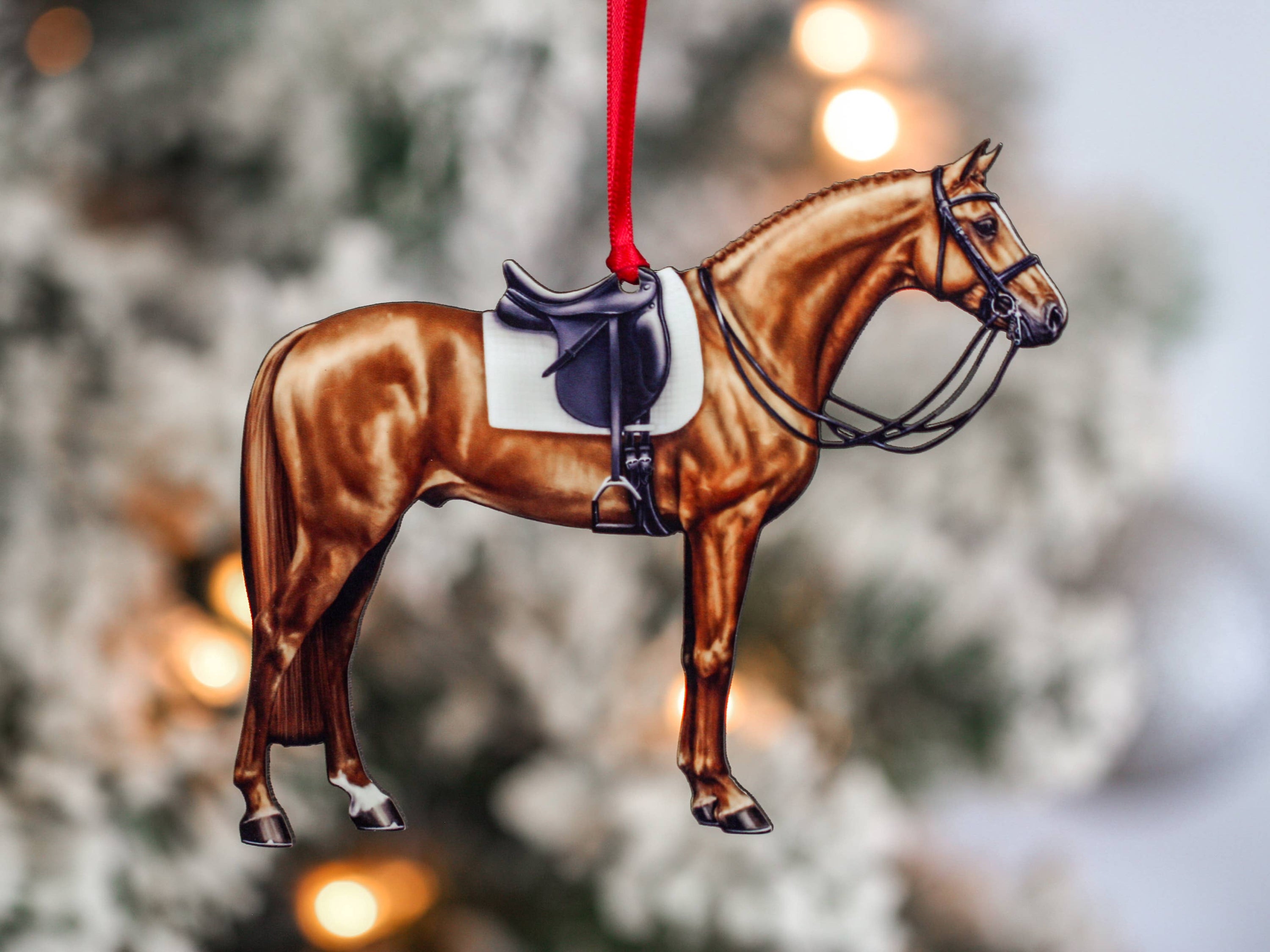 Handcrafted Chestnut Dressage Horse Christmas Ornament with red and black ribbons, made from composite wood, showcasing intricate laser-cut details.