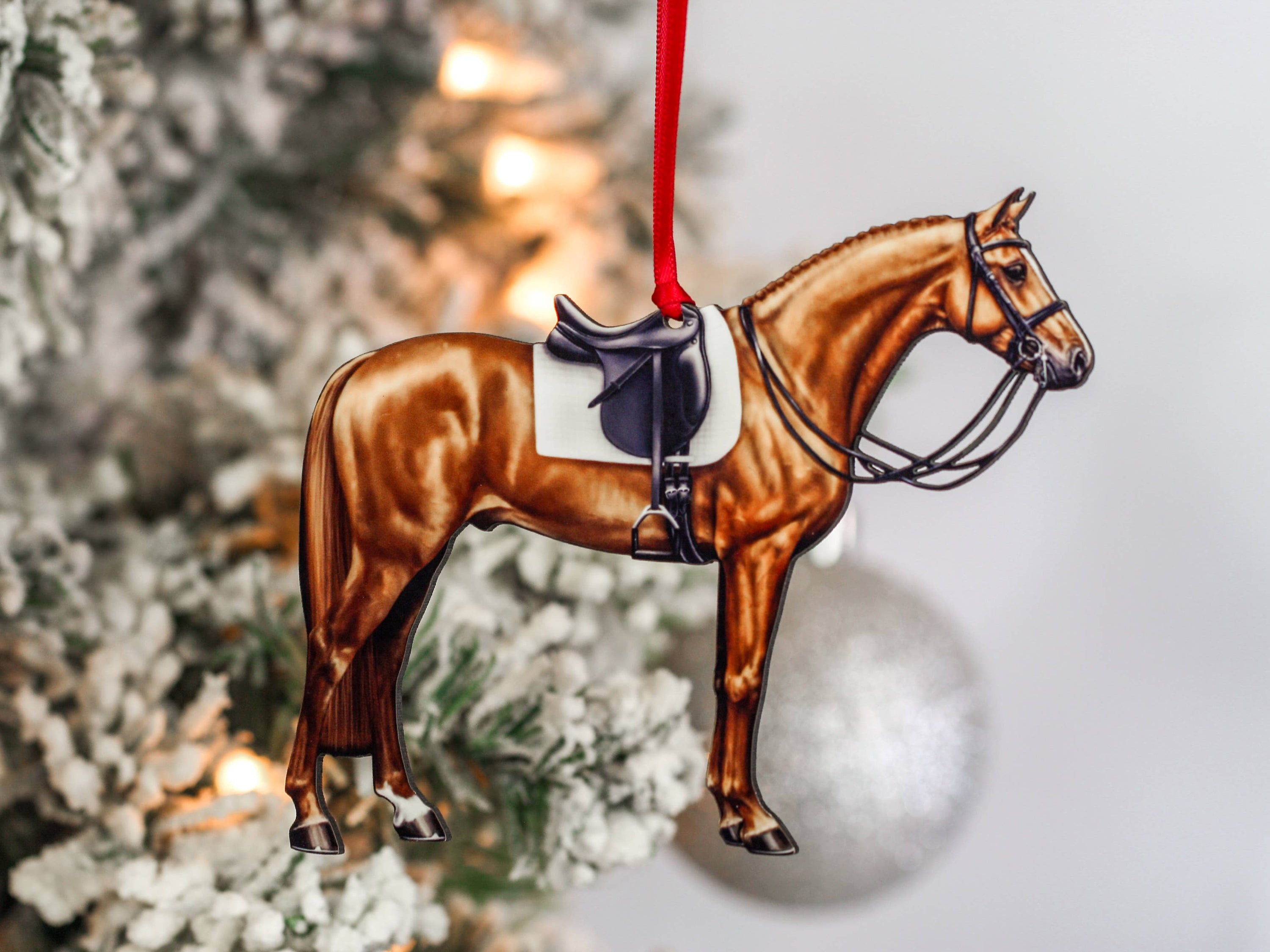Handcrafted Chestnut Dressage Horse Christmas Ornament with red and black ribbons, made from composite wood, showcasing intricate laser-cut details.