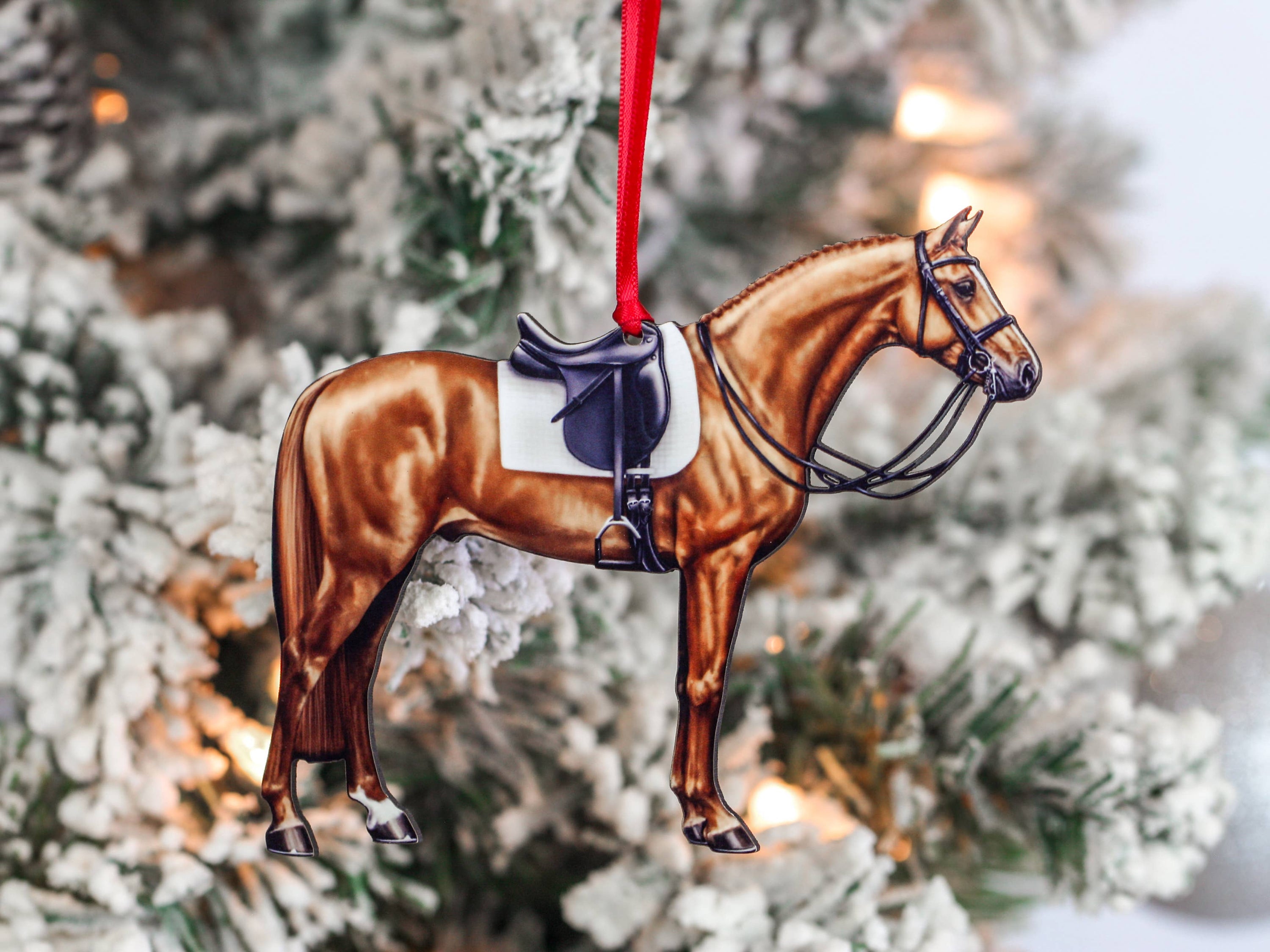 Handcrafted Chestnut Dressage Horse Christmas Ornament with red and black ribbons, made from composite wood, showcasing intricate laser-cut details.
