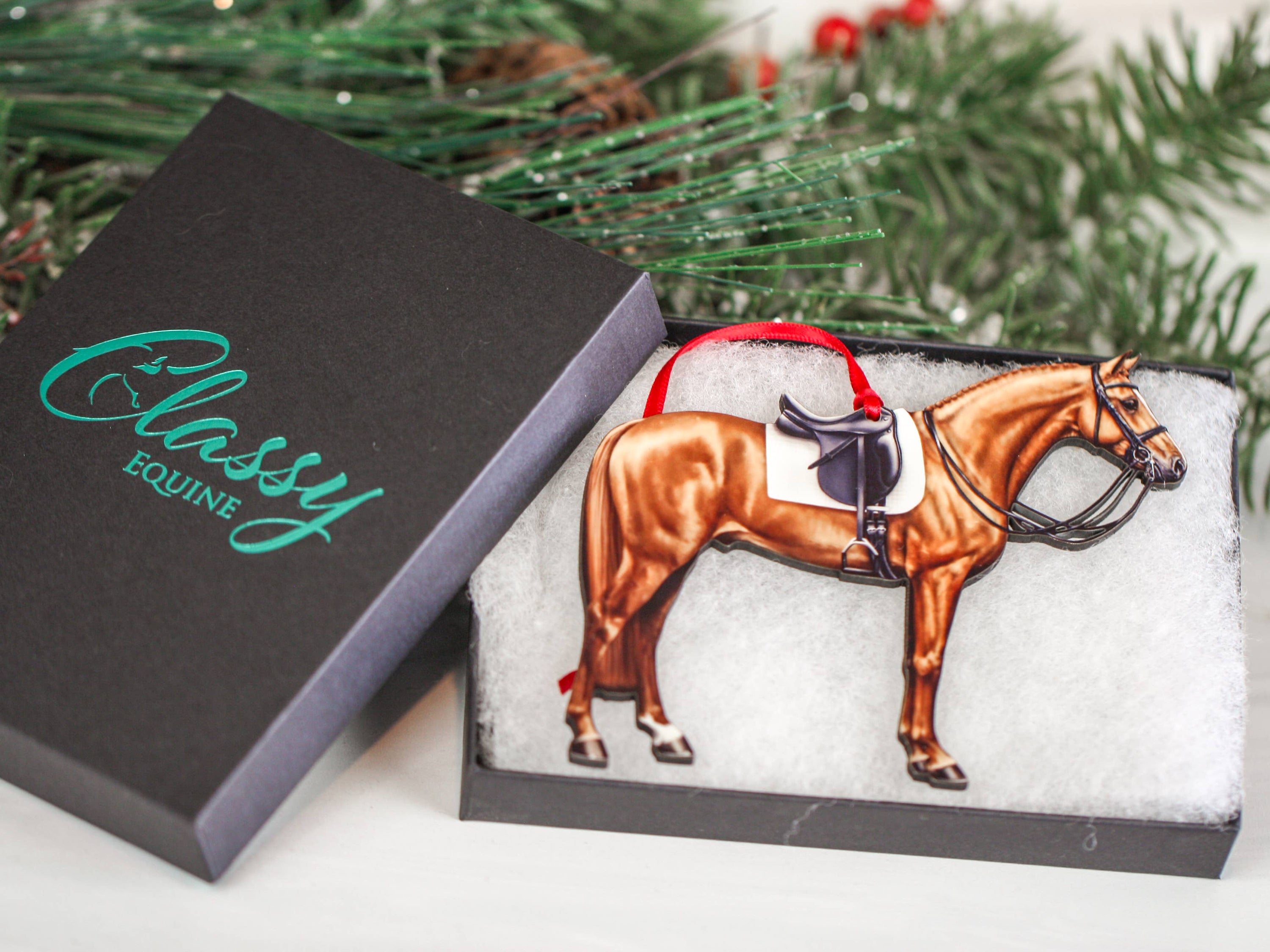 Handcrafted Chestnut Dressage Horse Christmas Ornament with red and black ribbons, made from composite wood, showcasing intricate laser-cut details.