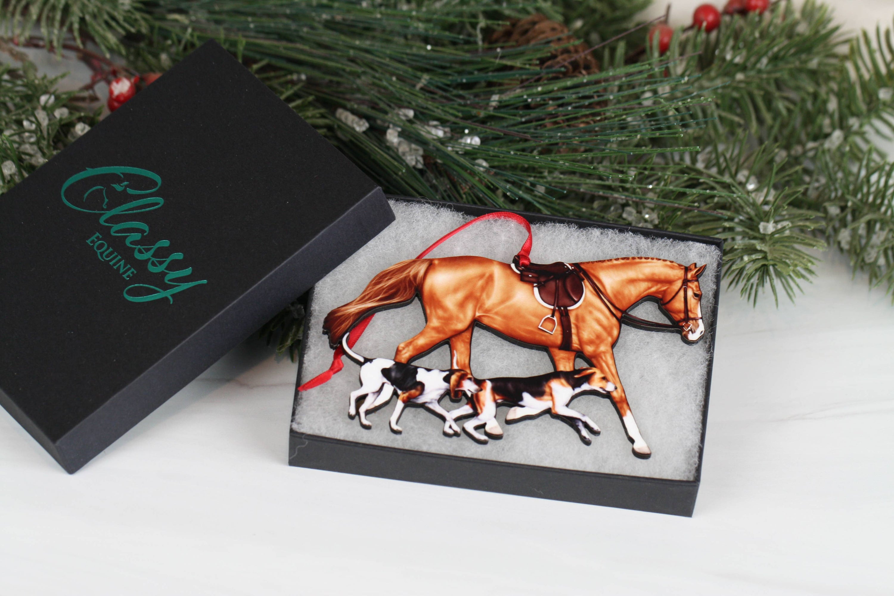 Chestnut Fox Hunter Horse and Hounds Ornament, handmade from composite wood, featuring a chestnut horse and two hounds, with red and black ribbons.