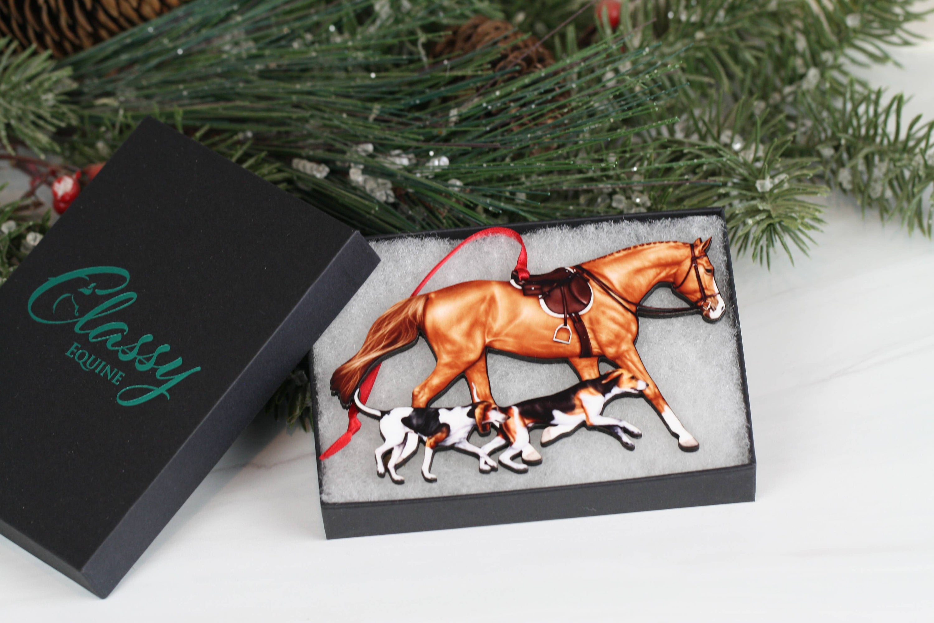 Chestnut Fox Hunter Horse and Hounds Ornament, handmade from composite wood, featuring a chestnut horse and two hounds, with red and black ribbons.