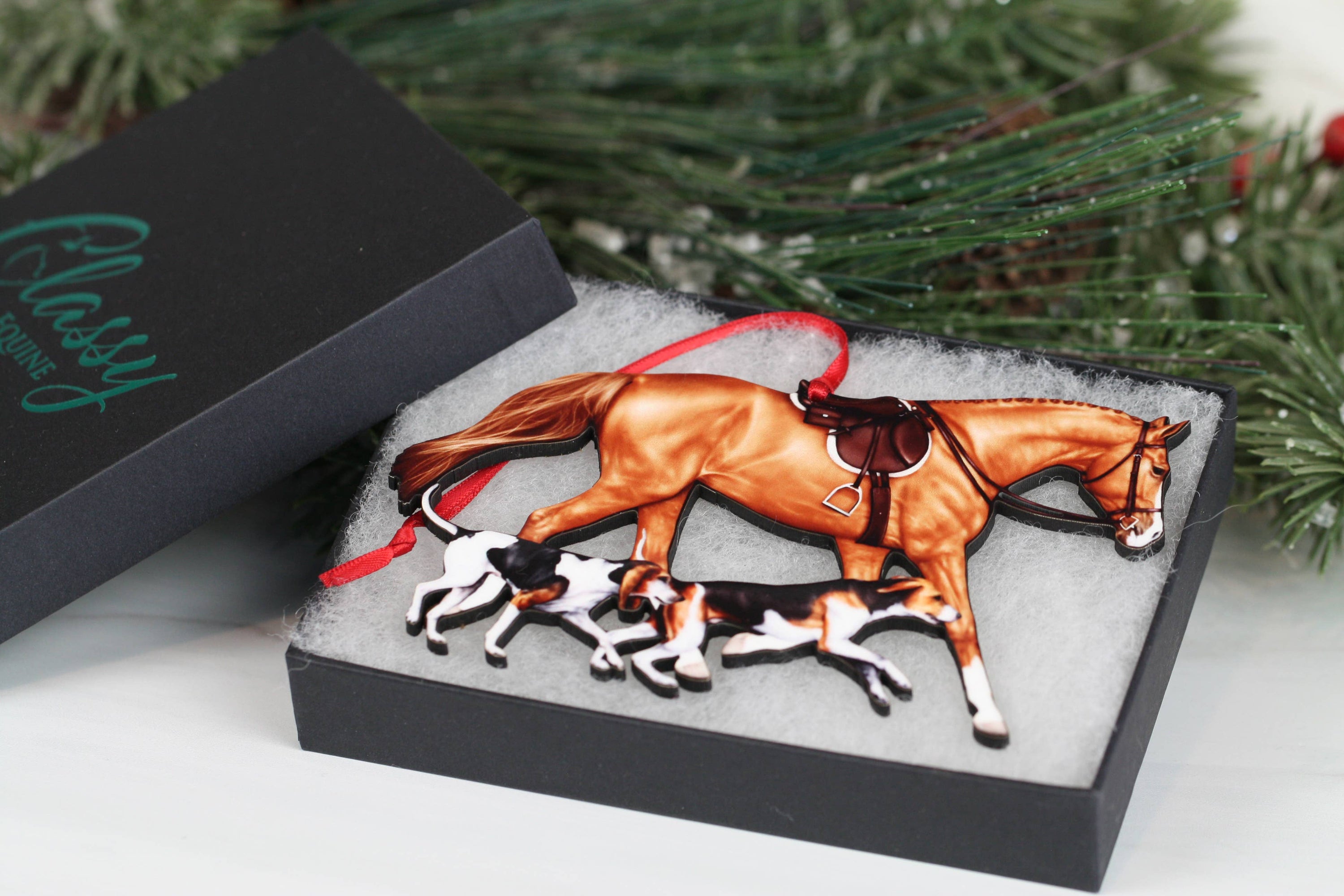 Chestnut Fox Hunter Horse and Hounds Ornament, handmade from composite wood, featuring a chestnut horse and two hounds, with red and black ribbons.