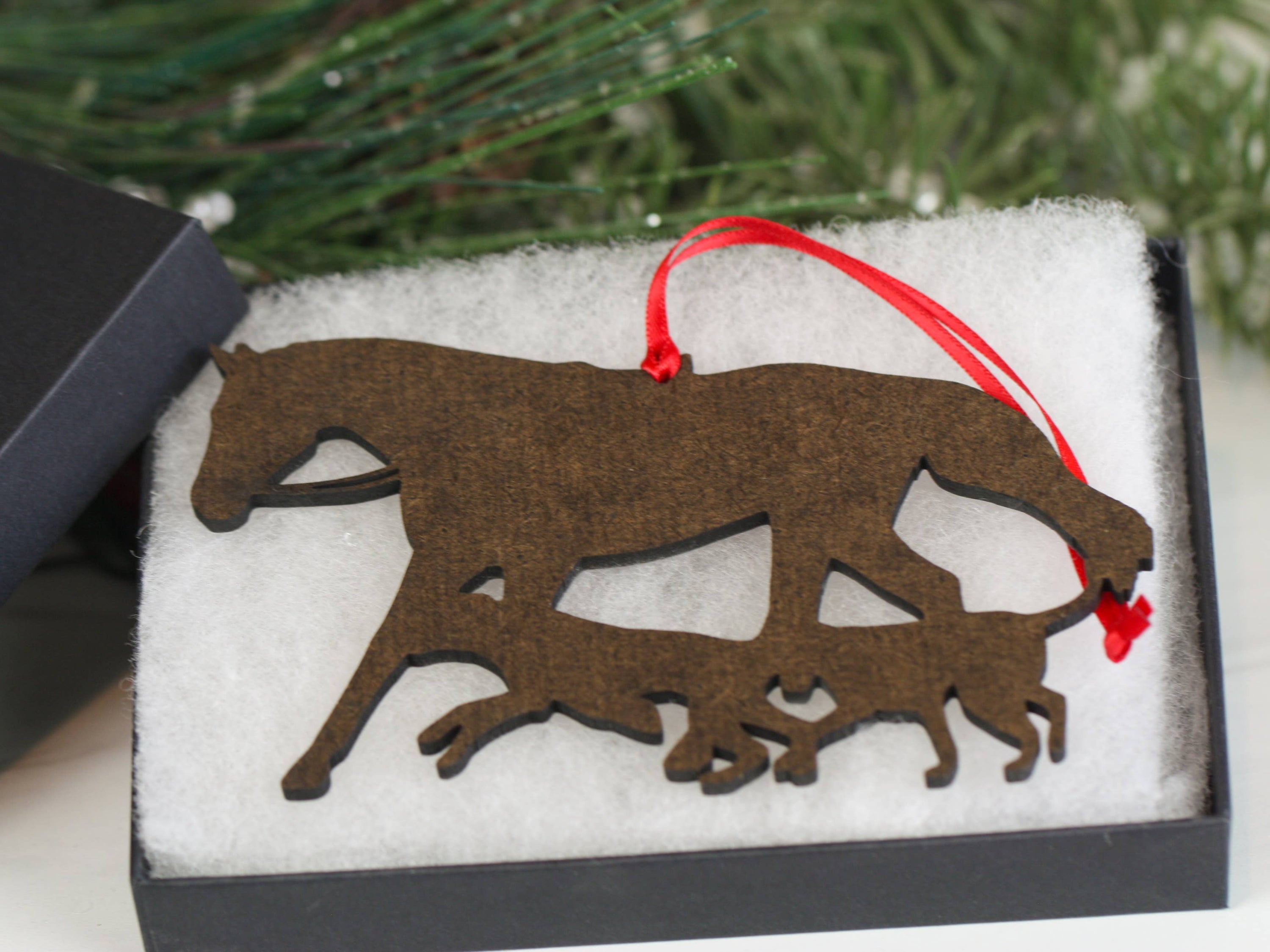Chestnut Fox Hunter Horse and Hounds Ornament, handmade from composite wood, featuring a chestnut horse and two hounds, with red and black ribbons.