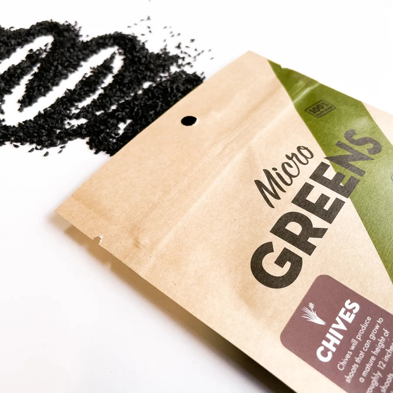 A close-up of chive microgreens growing in a small container, showcasing their vibrant green color and delicate leaves.