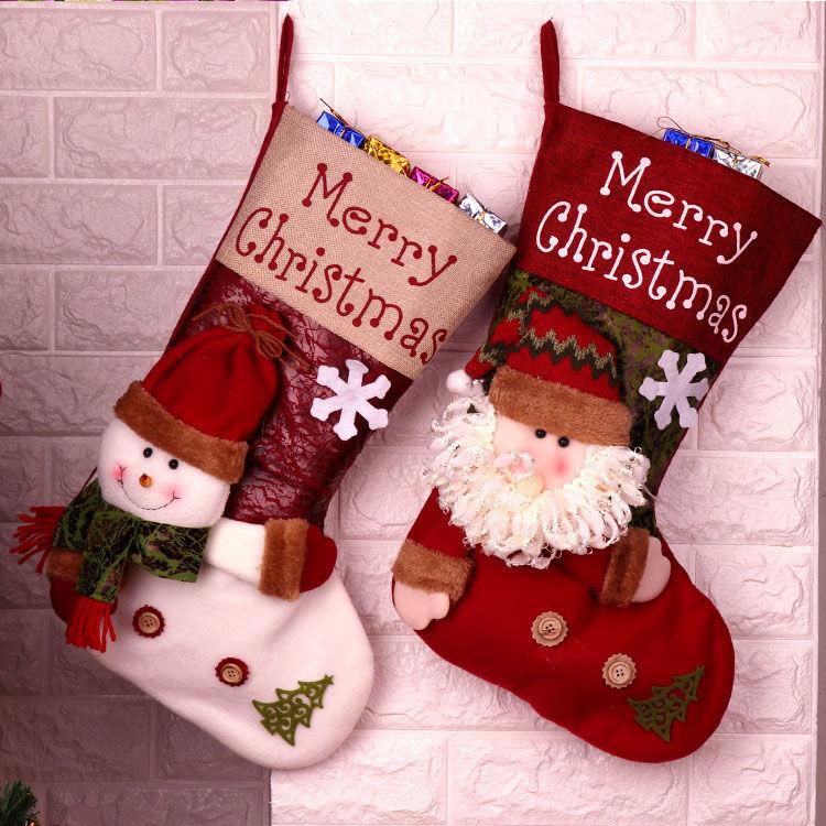 A festive Christmas socks gift bag featuring Santa Claus and snowman designs, perfect for holiday decorations and gift-giving.