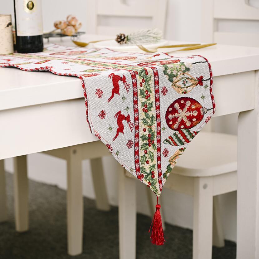 A beautifully knitted Christmas table runner in festive colors, perfect for holiday decorations.