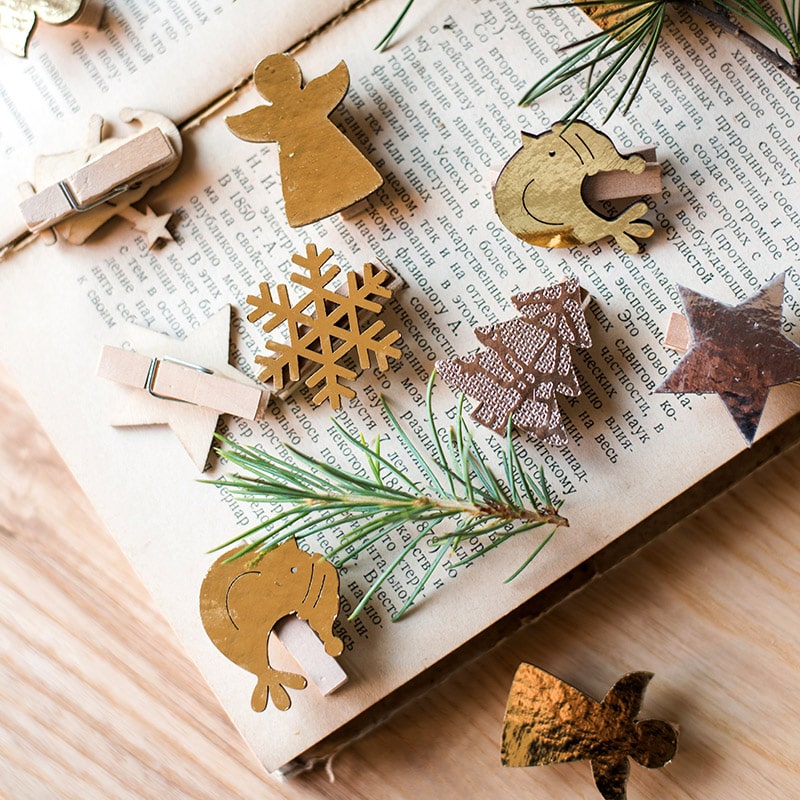 A set of 18 Christmas wood clips in various colors including gold and silver, perfect for holiday decorations and crafts.