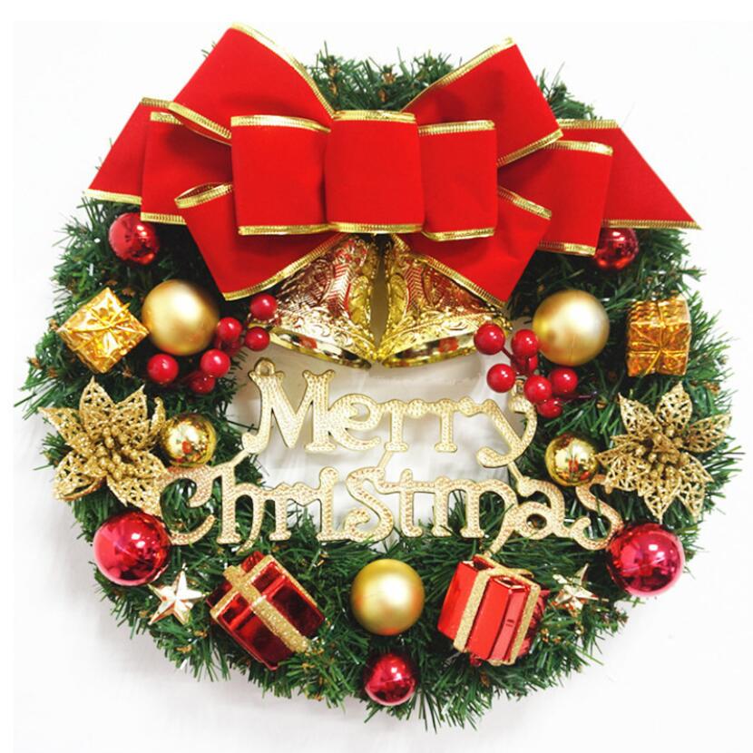 A beautifully decorated 30cm Christmas wreath featuring red bows, golden bells, and green pine branches, perfect for holiday decorations.