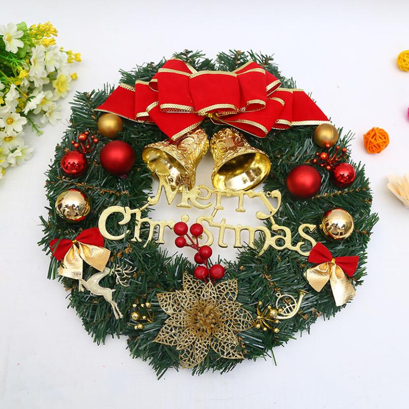 A beautifully decorated 30cm Christmas wreath featuring red bows, golden bells, and green pine branches, perfect for holiday decorations.
