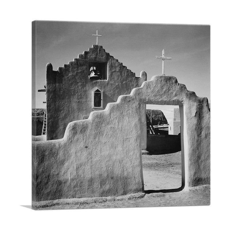A beautiful canvas print of the Church Gate at Taos Pueblo, showcasing its unique adobe architecture and cultural significance.