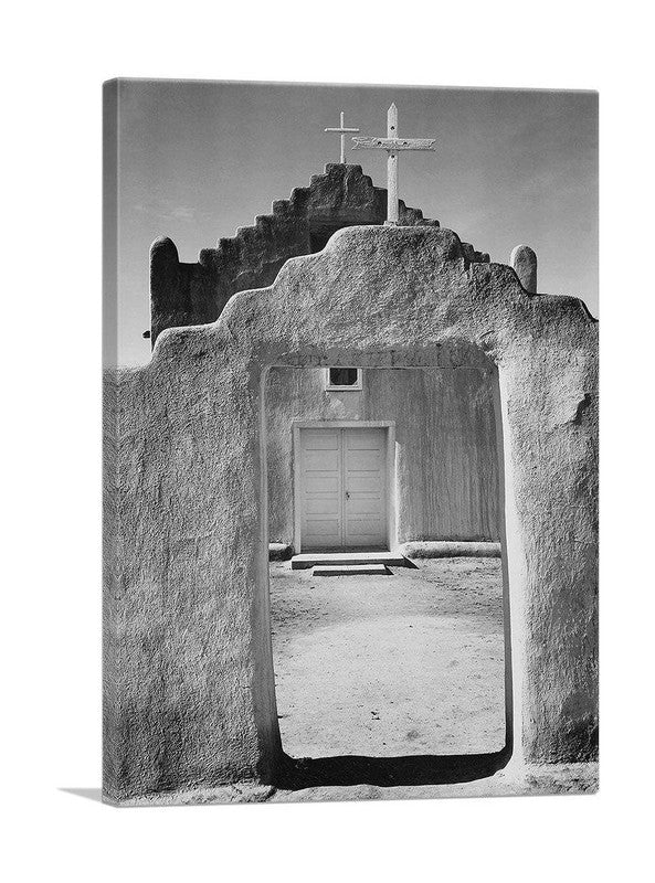 A beautiful canvas print of Taos Pueblo, showcasing its unique adobe architecture and stunning New Mexico landscape.