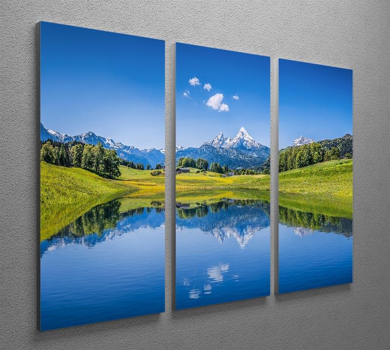 A stunning 3-panel canvas print featuring a clear mountain lake surrounded by fresh green trees, perfect for home decor.