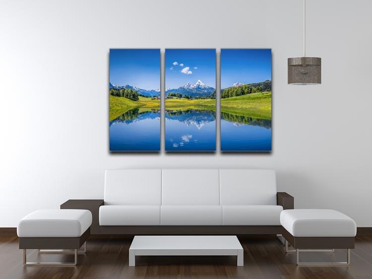 A stunning 3-panel canvas print featuring a clear mountain lake surrounded by fresh green trees, perfect for home decor.