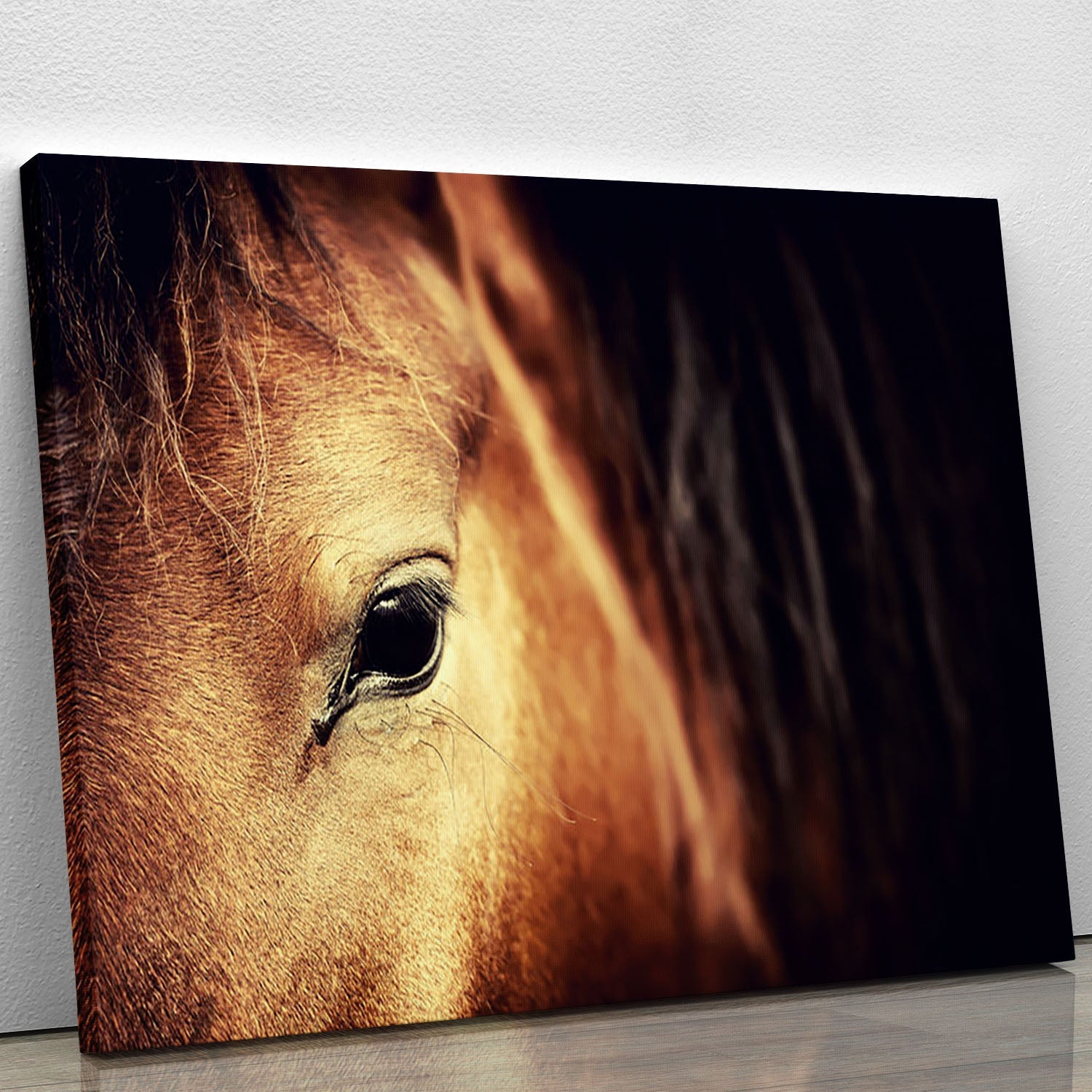 Close-up view of an Arabian bay horse's eye, showcasing its beauty and detail on a dark canvas print.