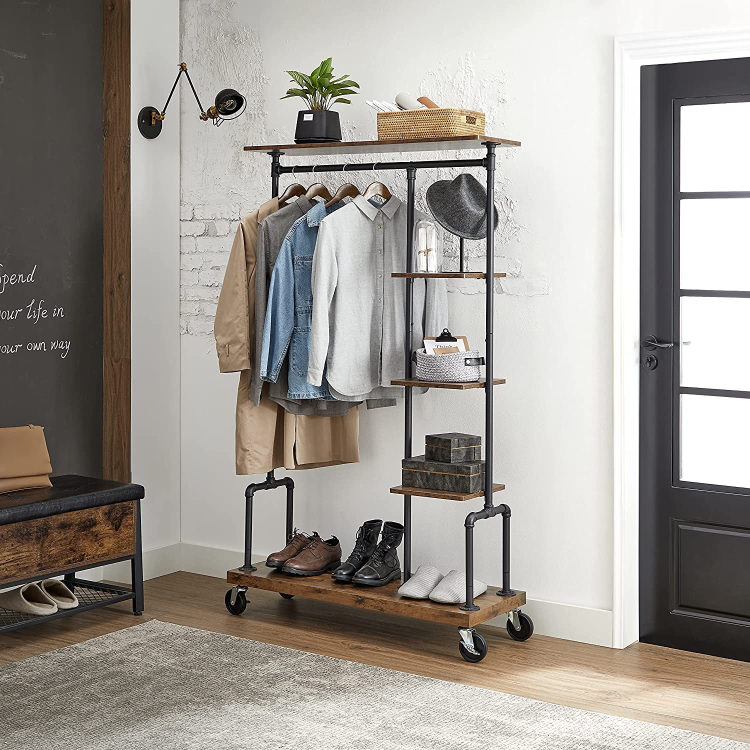 Clothing Garment Rack on Wheels featuring industrial pipe design and rustic brown shelves, showcasing clothes and accessories.