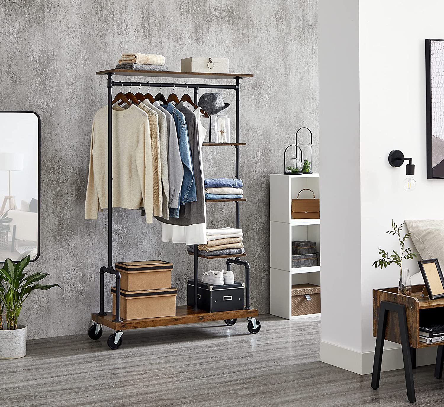 Clothing Garment Rack on Wheels featuring industrial pipe design and rustic brown shelves, showcasing clothes and accessories.