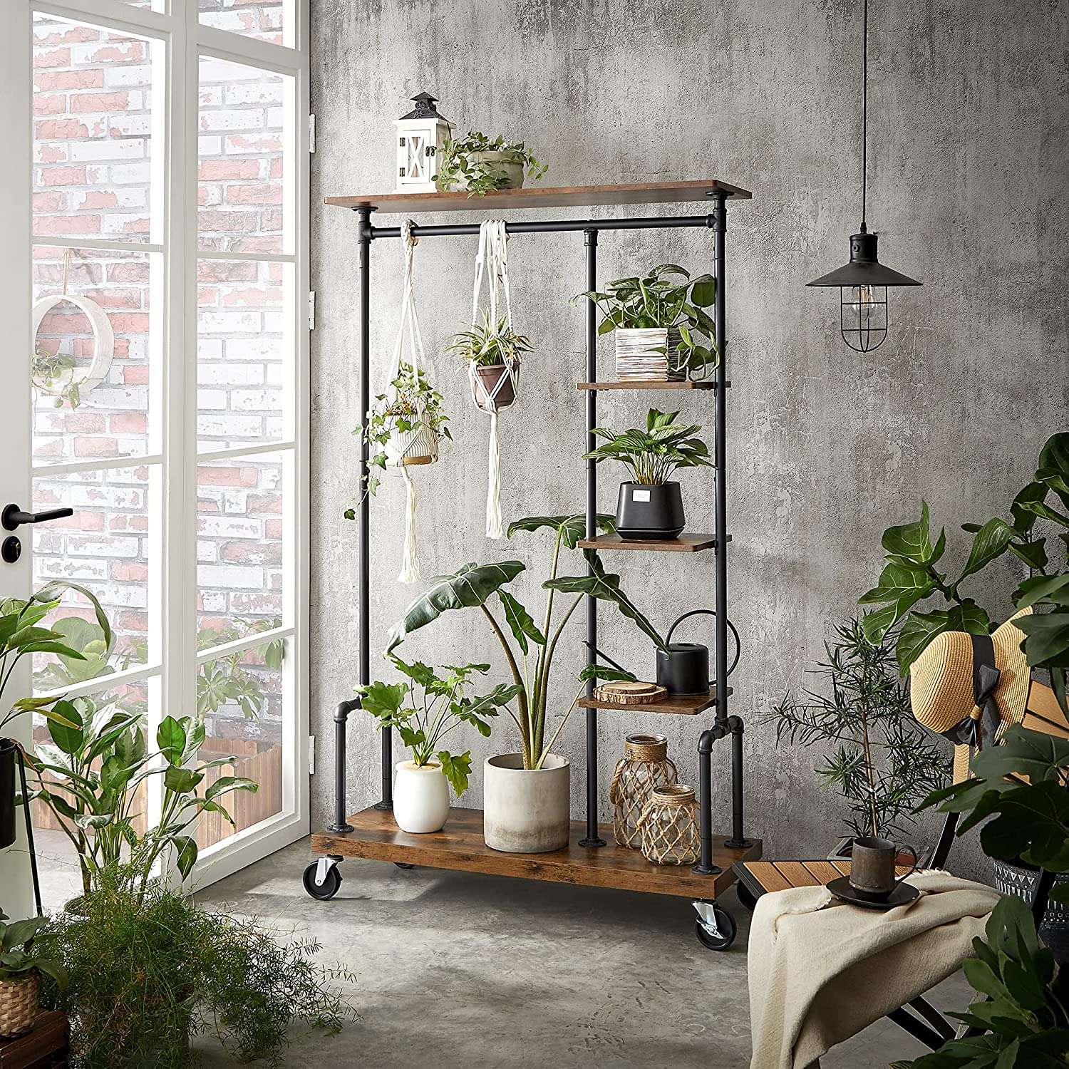 Clothing Garment Rack on Wheels featuring industrial pipe design and rustic brown shelves, showcasing clothes and accessories.