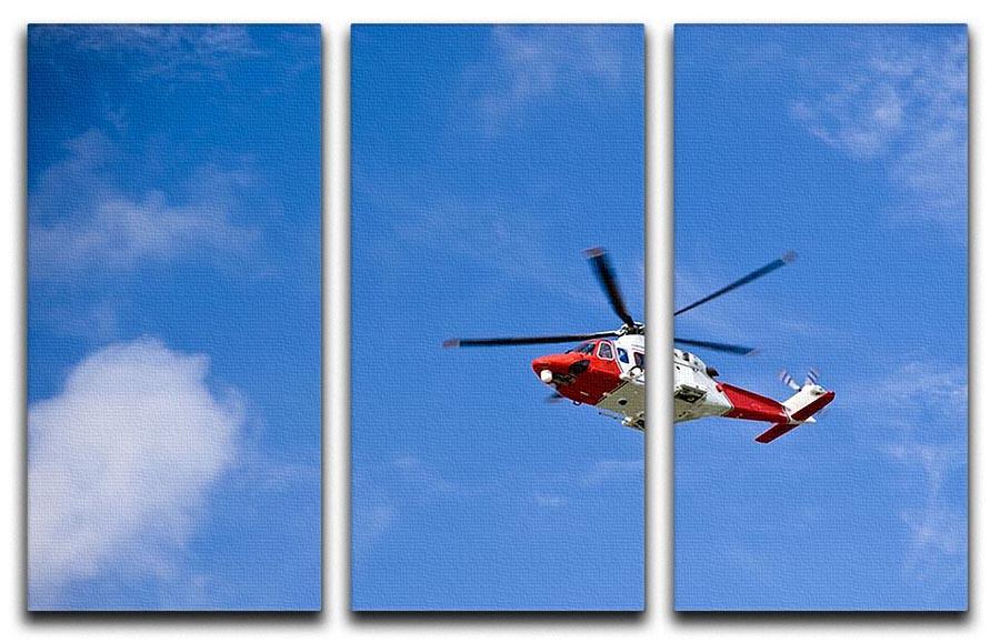 A stunning 3-panel canvas print featuring a Coastguard helicopter soaring in a clear blue sky, perfect for home or office decor.