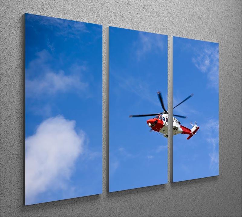 A stunning 3-panel canvas print featuring a Coastguard helicopter soaring in a clear blue sky, perfect for home or office decor.