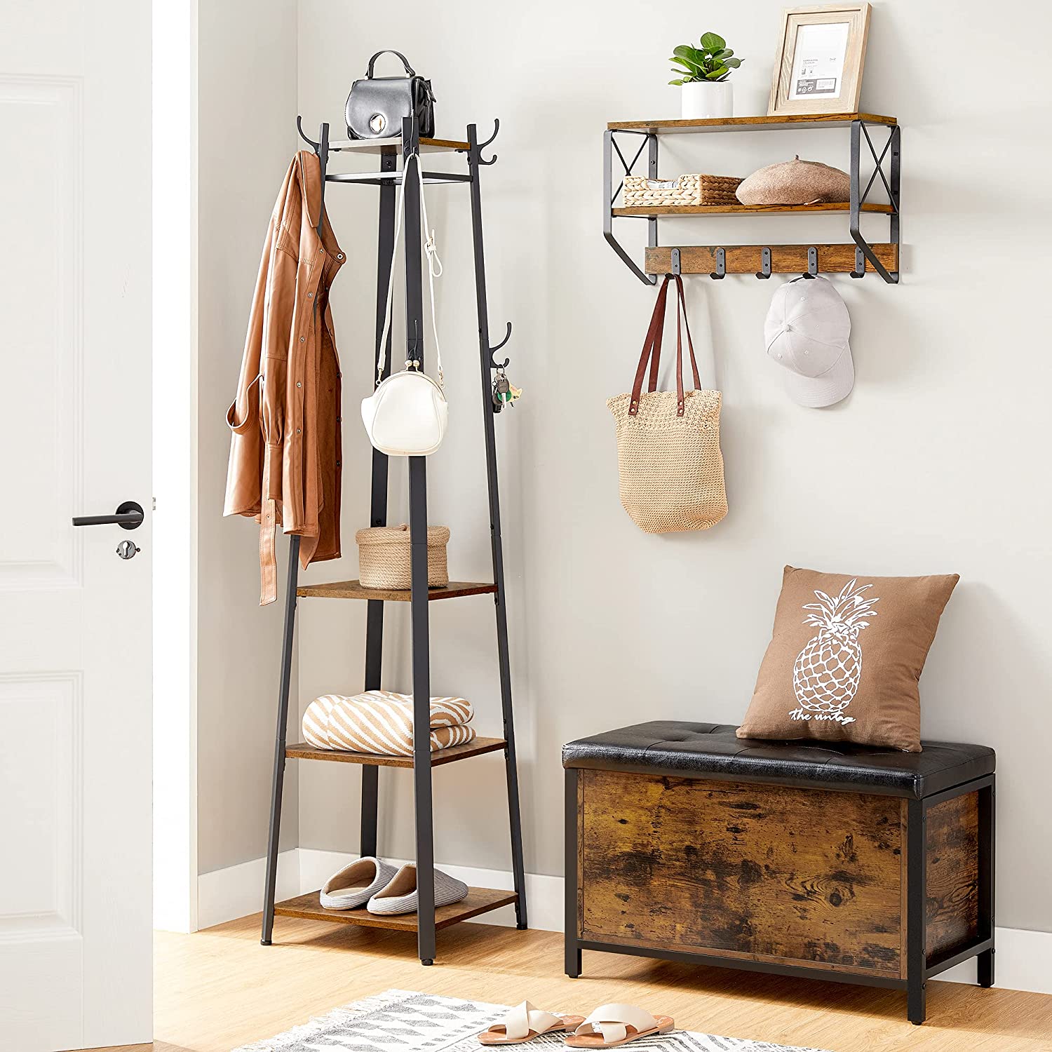 Rustic brown and black coat rack with three shelves and hooks, designed for stylish entryway organization.