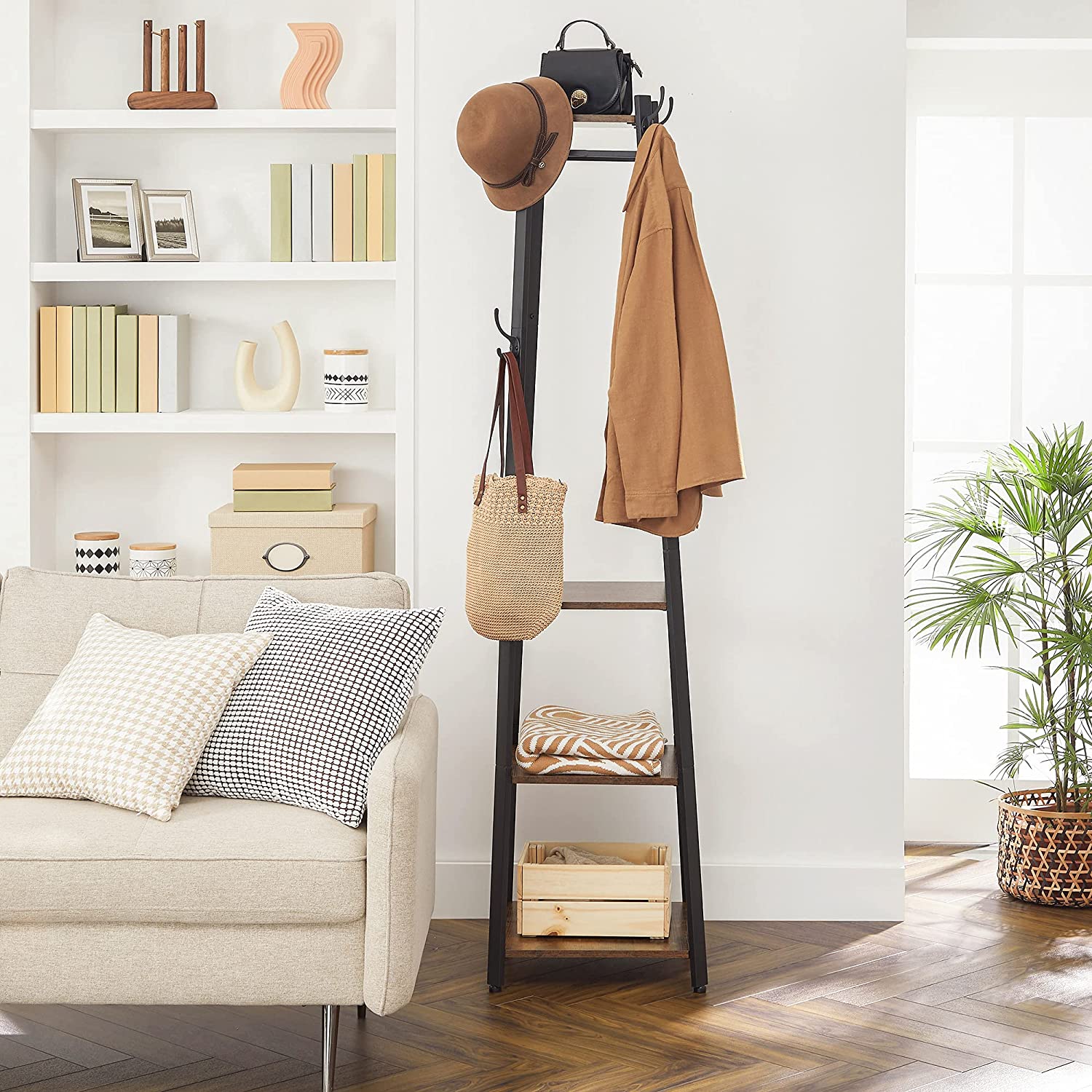 Rustic brown and black coat rack with three shelves and hooks, designed for stylish entryway organization.