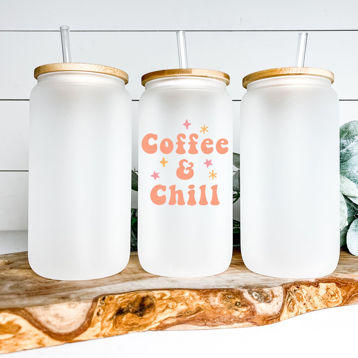Coffee and Chill Glass Can Tumbler with bamboo lid and clear straw, showcasing its frosted glass design.