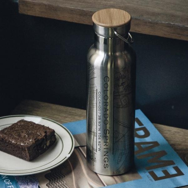 Custom engraved Colorado Springs map bottle with bamboo top, showcasing a detailed map and coordinates.