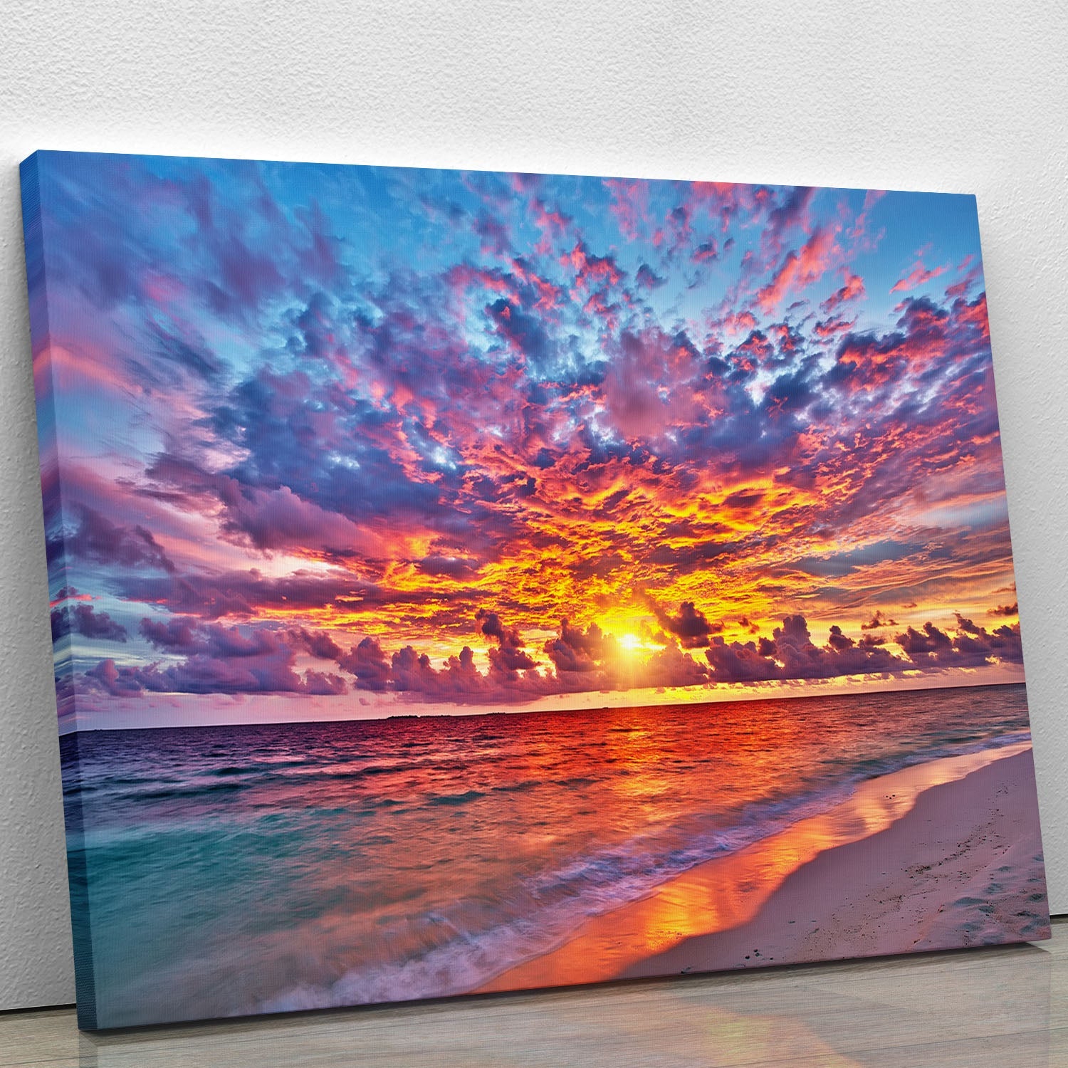 A vibrant canvas print of a colorful sunset over the ocean in the Maldives, showcasing rich hues of orange, pink, and purple reflecting on the water.