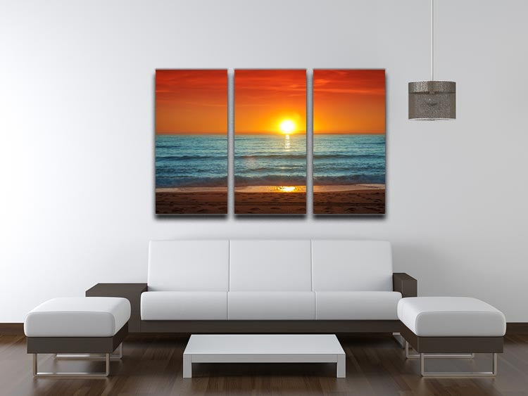 A vibrant 3-panel canvas print depicting a colorful sunset over the sea, showcasing rich hues of orange, pink, and purple.
