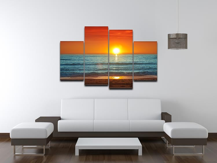 A vibrant 4-panel canvas artwork depicting a colorful sunset over the sea, showcasing rich oranges, pinks, and purples.