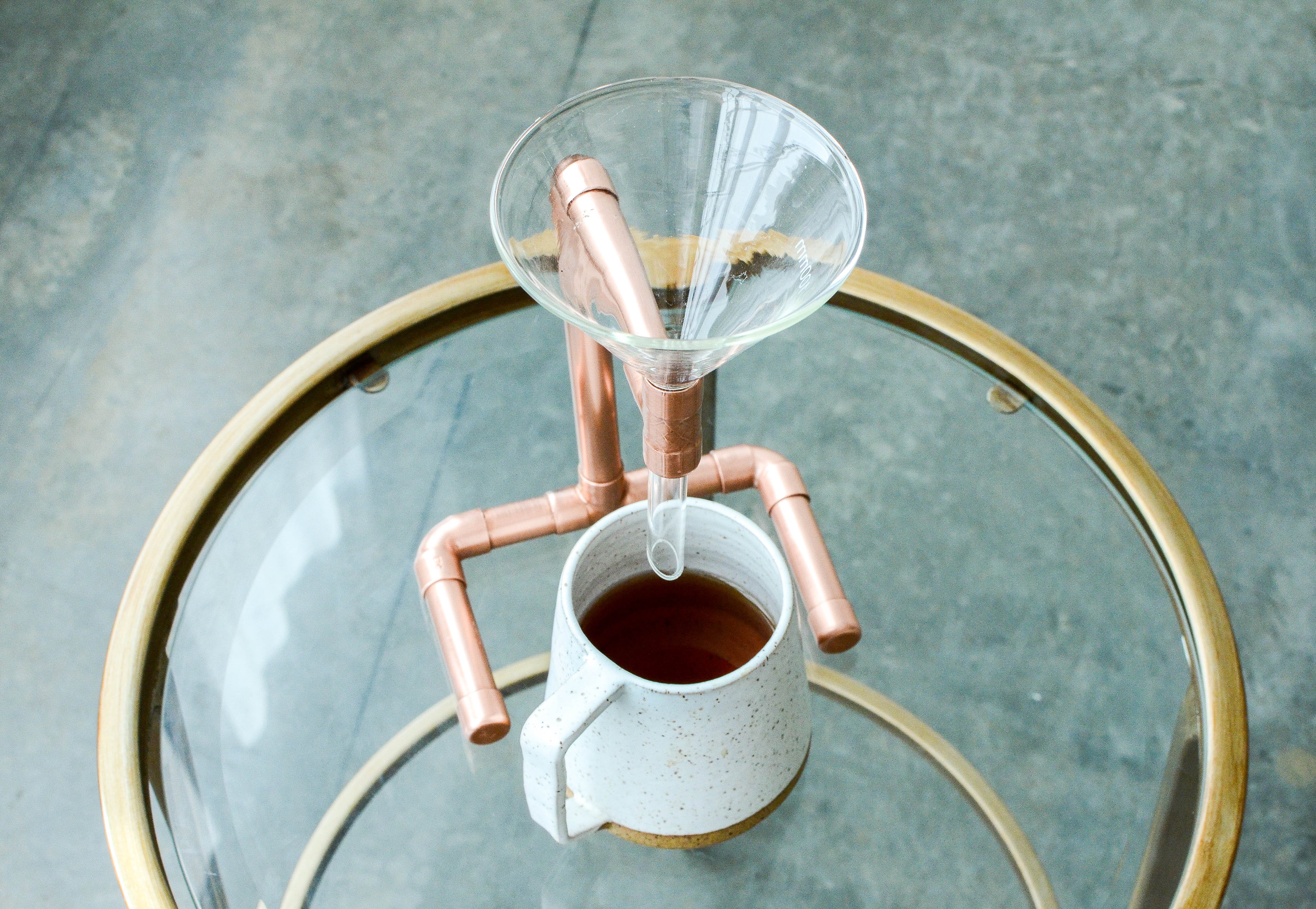 A beautifully crafted Copper Coffee Pour Over with a sleek, minimalist design, showcasing its hand-polished finish and elegant shape.