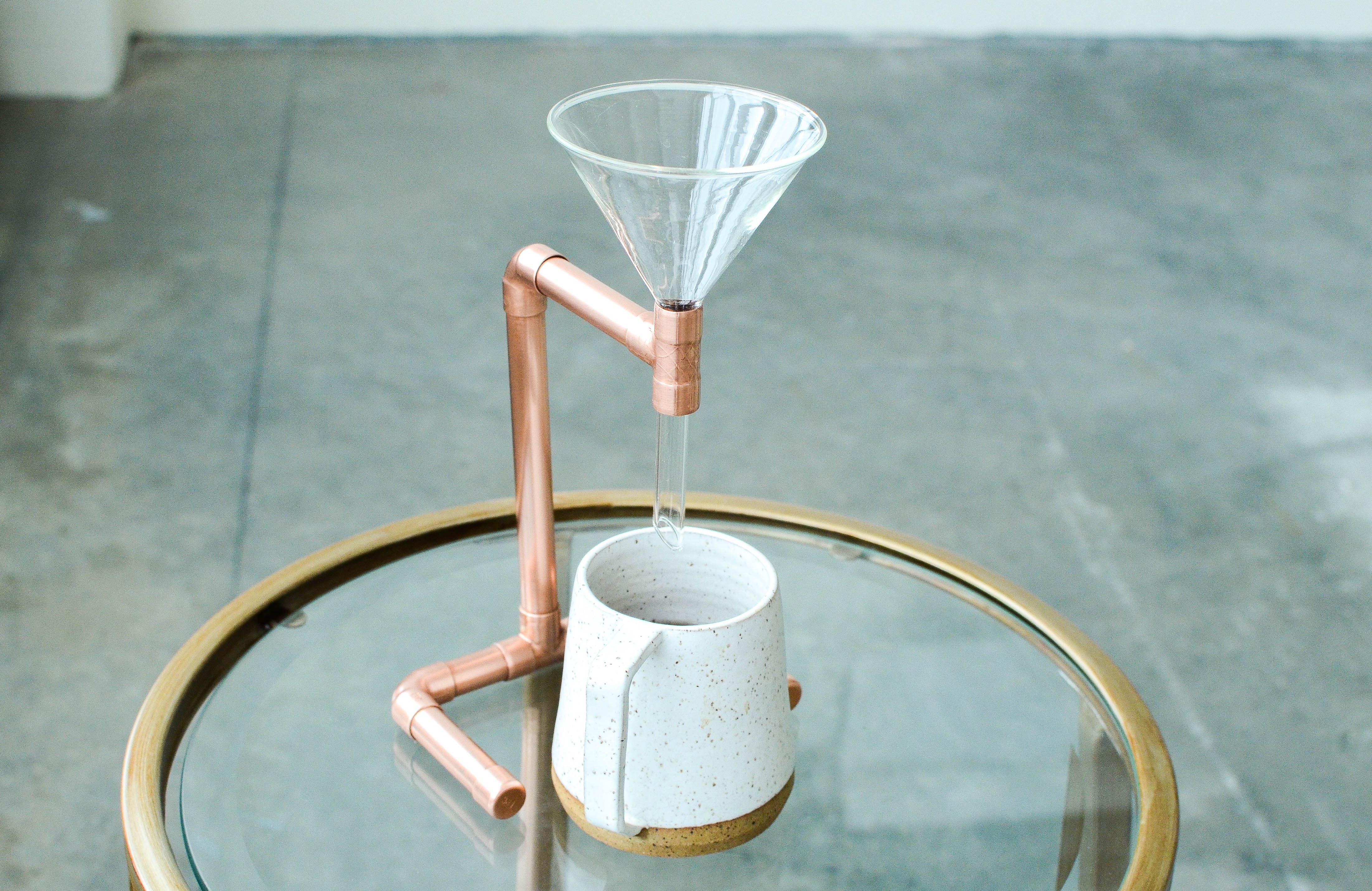 A beautifully crafted Copper Coffee Pour Over with a sleek, minimalist design, showcasing its hand-polished finish and elegant shape.