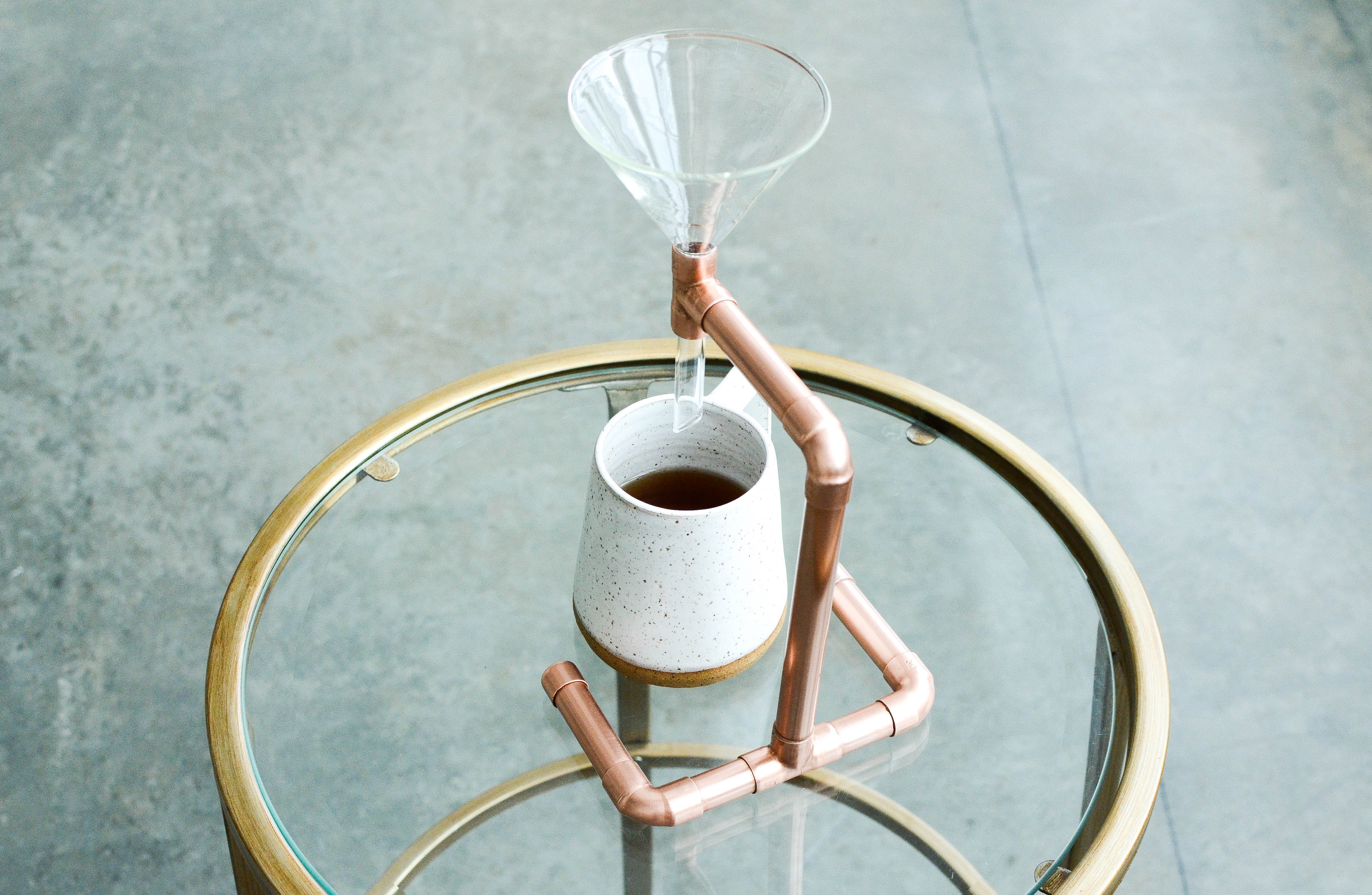 A beautifully crafted Copper Coffee Pour Over with a sleek, minimalist design, showcasing its hand-polished finish and elegant shape.