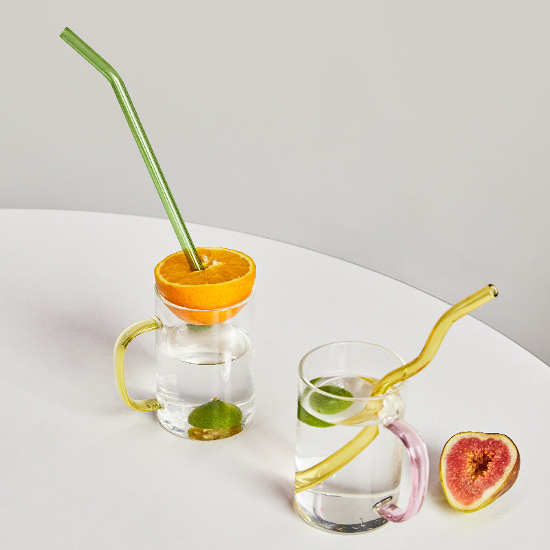Curvy Glass Straw Set featuring colorful, elegant straws made from durable borosilicate glass, with a cleaning brush included.