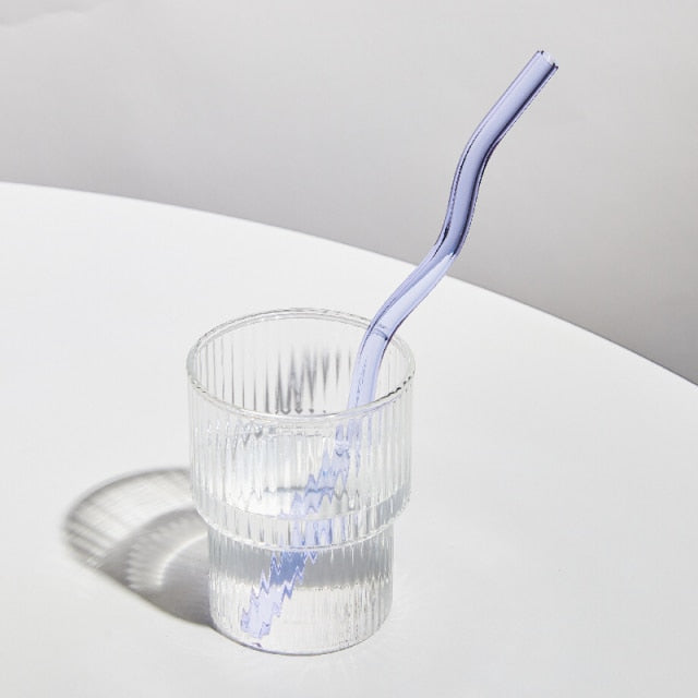 Curvy Glass Straw Set featuring colorful, elegant straws made from durable borosilicate glass, with a cleaning brush included.