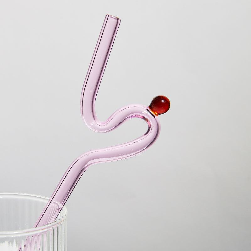Curvy Glass Straw Set featuring colorful, elegant straws made from durable borosilicate glass, with a cleaning brush included.