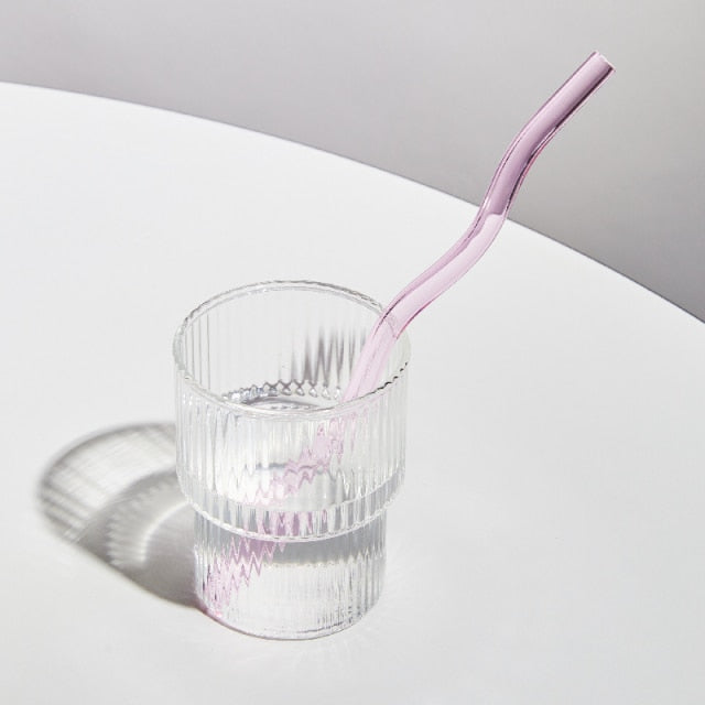 Curvy Glass Straw Set featuring colorful, elegant straws made from durable borosilicate glass, with a cleaning brush included.