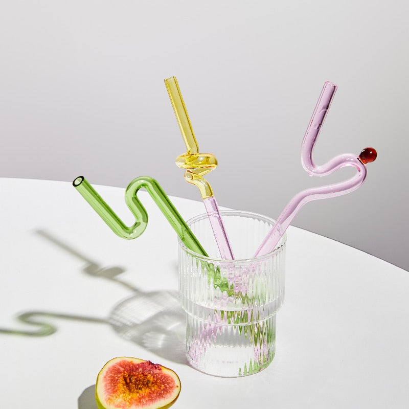 Curvy Glass Straw Set featuring colorful, elegant straws made from durable borosilicate glass, with a cleaning brush included.
