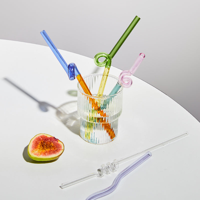 Curvy Glass Straw Set featuring colorful, elegant straws made from durable borosilicate glass, with a cleaning brush included.