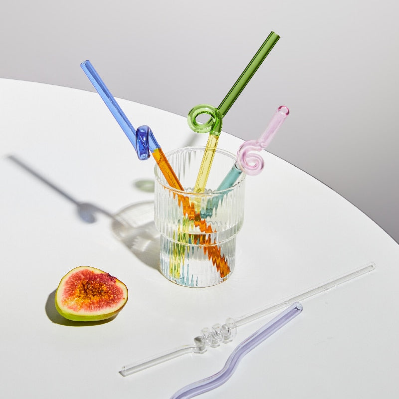 Curvy Glass Straw Set featuring colorful, elegant straws made from durable borosilicate glass, with a cleaning brush included.