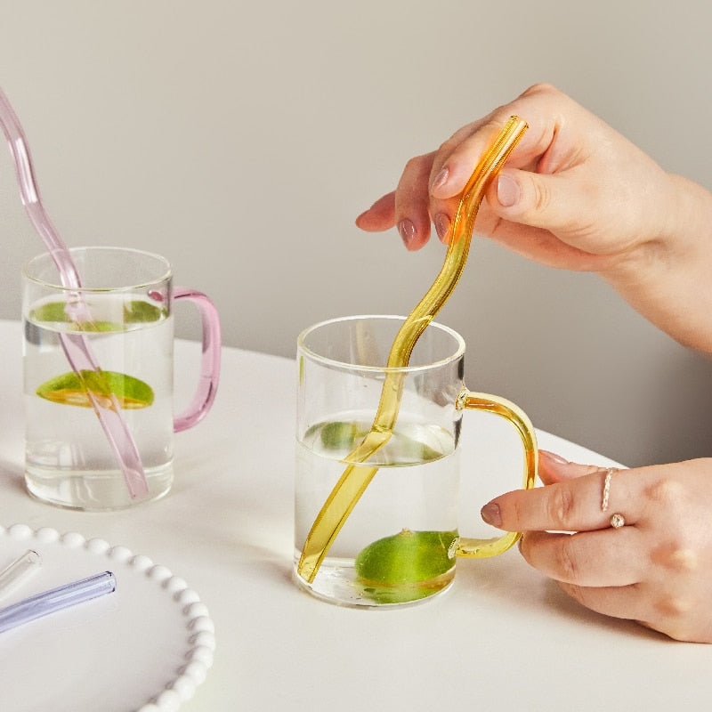 Curvy Glass Straw Set featuring colorful, elegant straws made from durable borosilicate glass, with a cleaning brush included.
