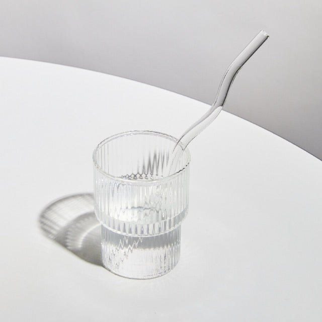 Curvy Glass Straw Set featuring colorful, elegant straws made from durable borosilicate glass, with a cleaning brush included.