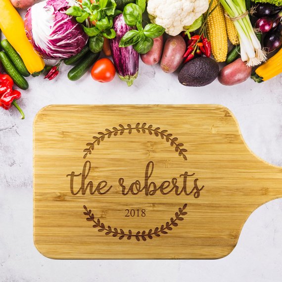 Custom bamboo cutting board with laser-etched design, showcasing dual-purpose functionality for food preparation and display.