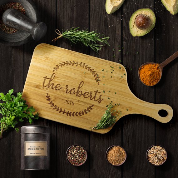 Custom bamboo cutting board with laser-etched design, showcasing dual-purpose functionality for food preparation and display.